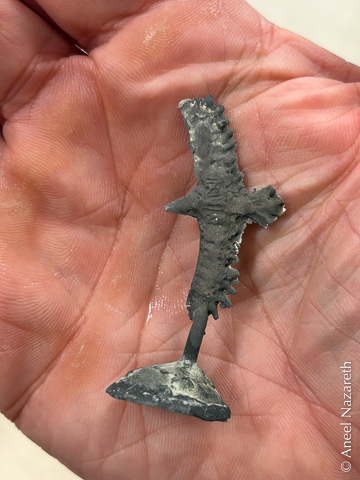 The cast version has some black oxide on the silver, but is the right shape